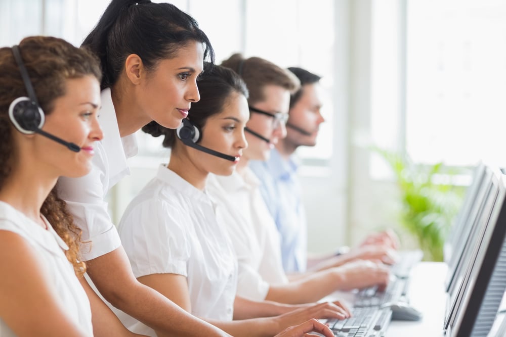 Side view of female manager assisting her staffs in a call center